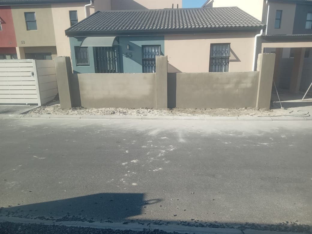 Newly plastered boundary wall and pillars in front of a house