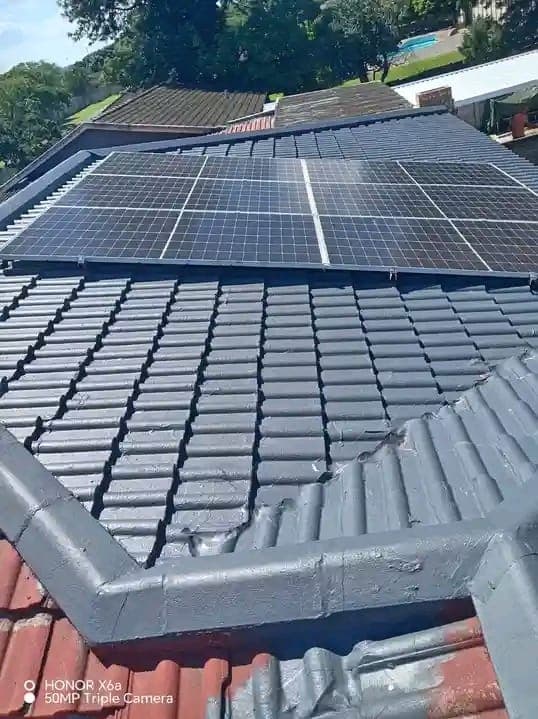 Solar panels mounted on a grey tiled roof
