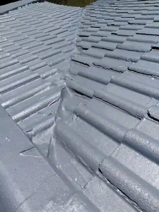 Silver waterproofing membrane applied over roof tiles