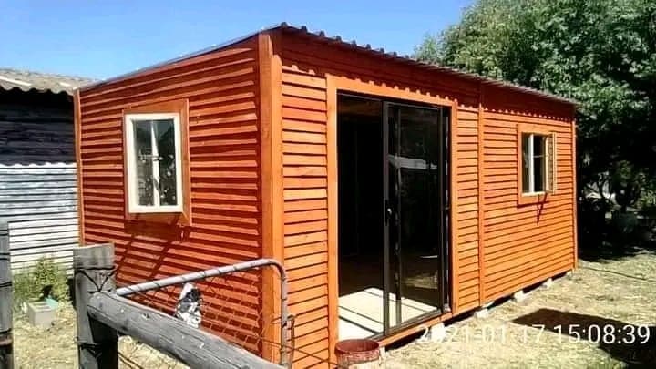Larger timber Wendy house with sliding glass door on raised platform